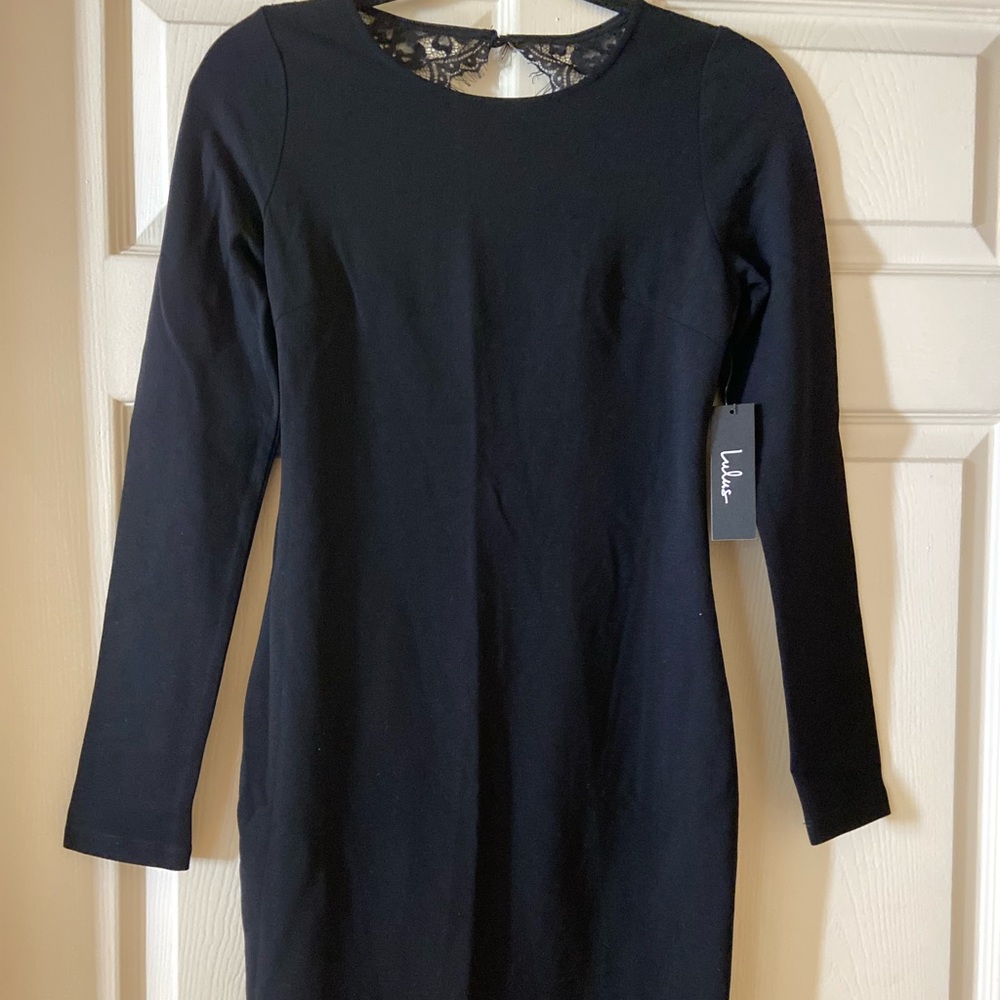 Brand NEW form fitting black dress. Beautiful detail in back.